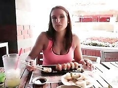 Misty Anderson eats sushi at an outdoor restaurant